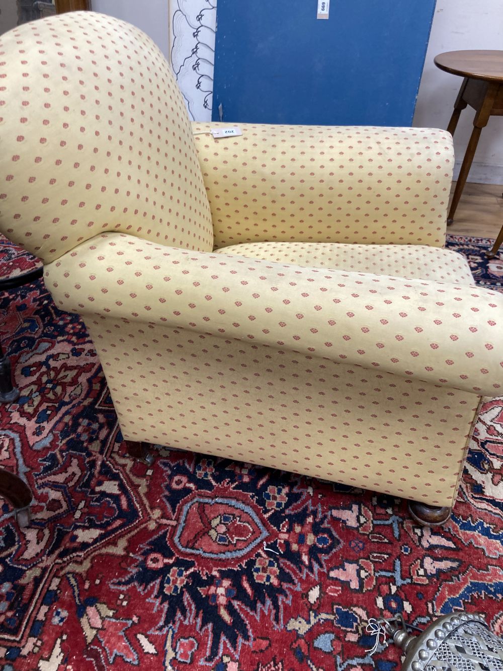 An early 20th century upholstered club armchair